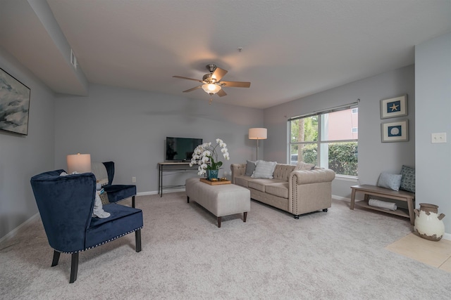 carpeted living room with ceiling fan