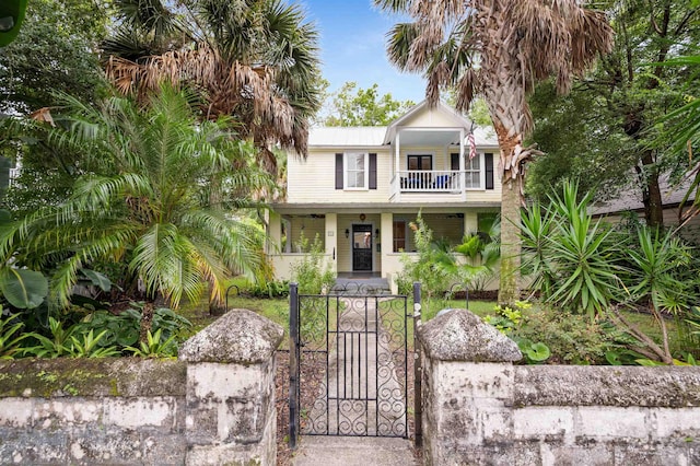 15 Rohde Ave, Saint Augustine, FL 32084 - view of front of home with a porch, a gate, a balcony, and a fenced front yard