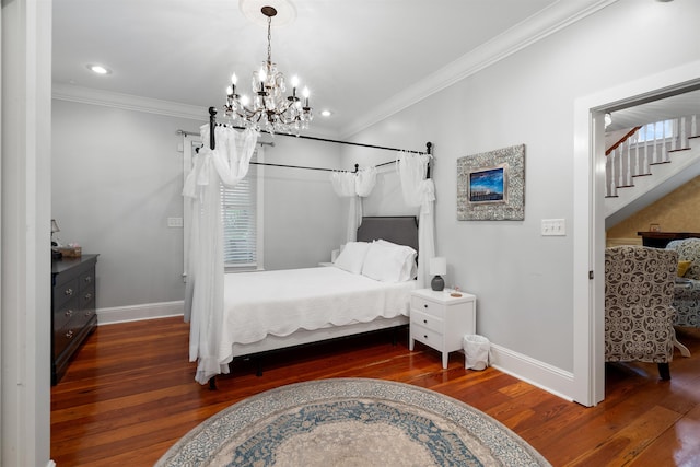 bedroom with dark hardwood / wood-style floors, crown molding, and a notable chandelier