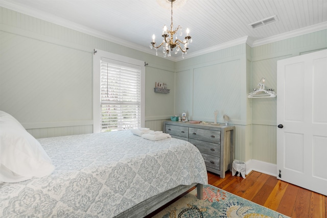 15 Rohde Ave, Saint Augustine, FL 32084 - bedroom with ornamental molding, a chandelier, wood finished floors, and a decorative wall