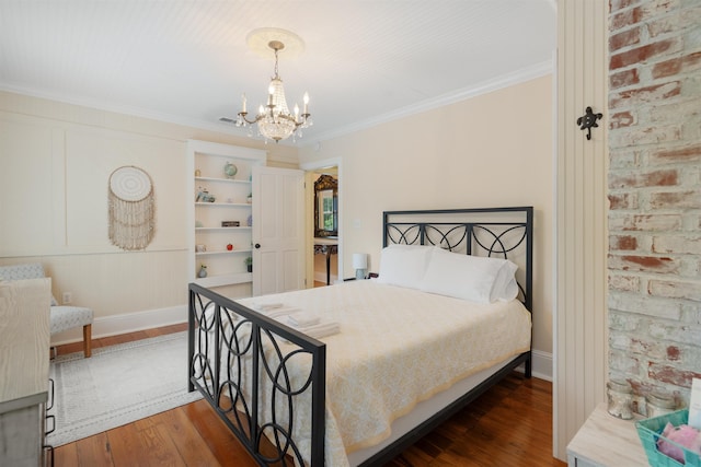 bedroom featuring a chandelier, dark hardwood / wood-style floors, and ornamental molding