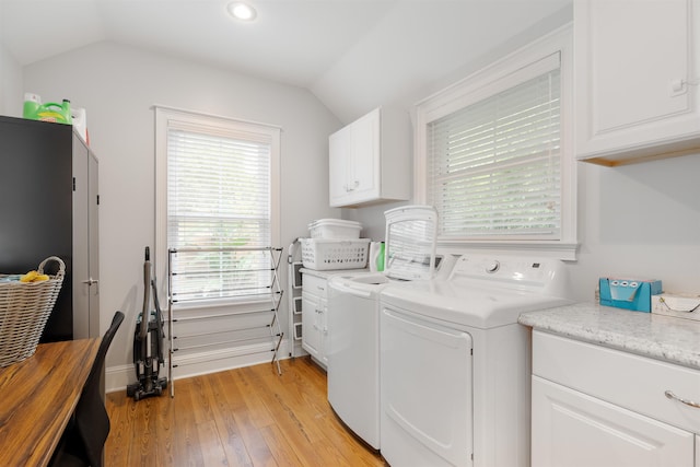 washroom with light hardwood / wood-style floors, cabinets, and independent washer and dryer