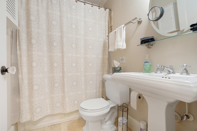 bathroom with tile patterned flooring, a shower with curtain, and toilet