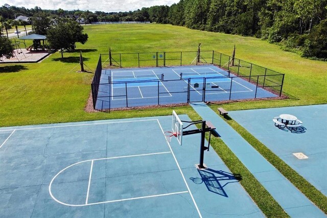520 Florida Club Blvd Unit 101, Saint Augustine, FL 32084 - exterior space with community basketball court, a tennis court, fence, and a lawn