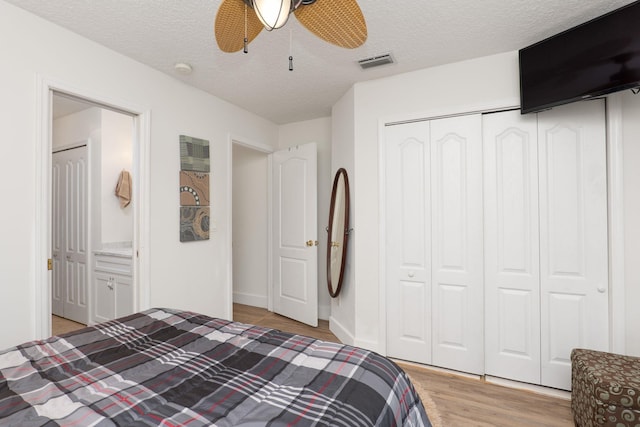 1300 Paradise Pond Rd, Saint Augustine, FL 32092 - bedroom with light wood finished floors, a closet, ceiling fan, and a textured ceiling