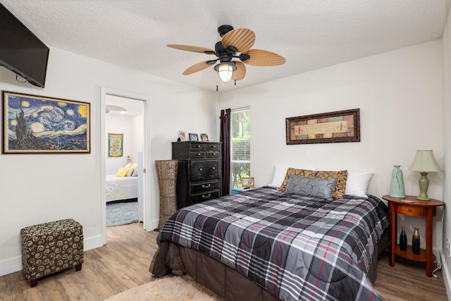 1300 Paradise Pond Rd, Saint Augustine, FL 32092 - bedroom featuring wood finished floors, baseboards, a textured ceiling, and ceiling fan