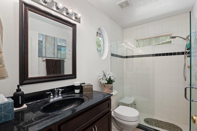 1300 Paradise Pond Rd, Saint Augustine, FL 32092 - bathroom featuring a stall shower, toilet, vanity, and a textured ceiling