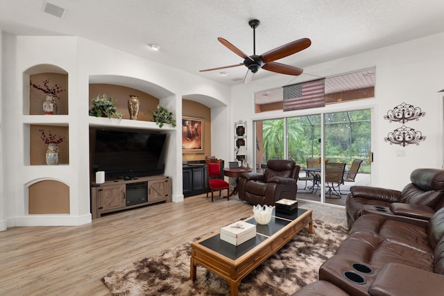 1300 Paradise Pond Rd, Saint Augustine, FL 32092 - living area with light wood-type flooring, a ceiling fan, and a textured ceiling