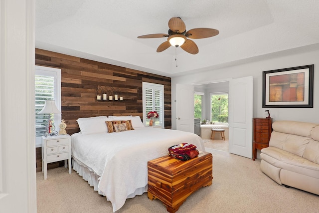1300 Paradise Pond Rd, Saint Augustine, FL 32092 - bedroom with wood walls, carpet, multiple windows, ensuite bath, and a ceiling fan
