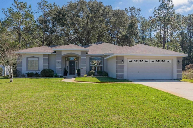 view of front of home with a garage, stucco siding, driveway, and a front yard