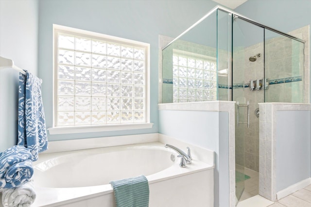 bathroom featuring shower with separate bathtub