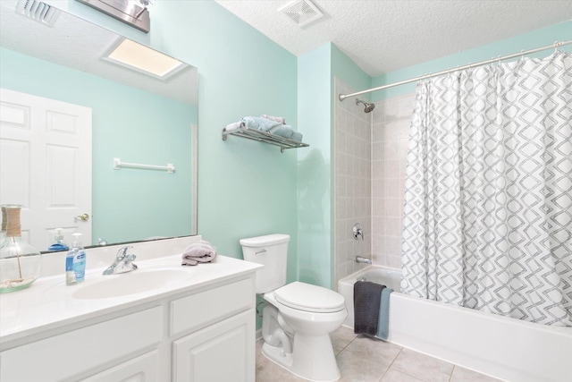 full bathroom with a textured ceiling, tile patterned floors, vanity, toilet, and shower / bath combo with shower curtain