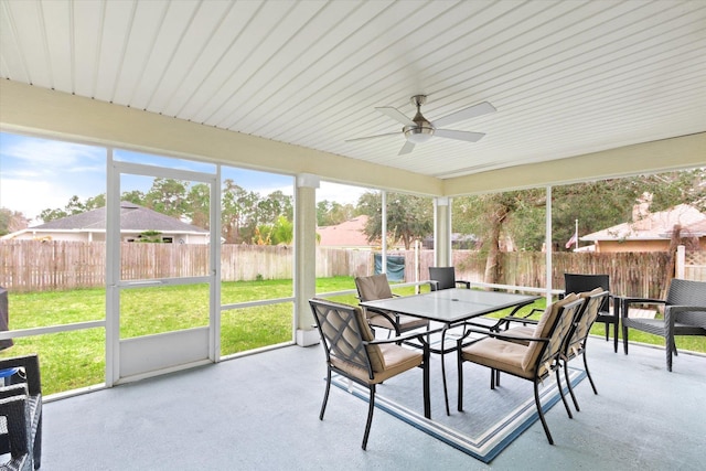 sunroom featuring ceiling fan