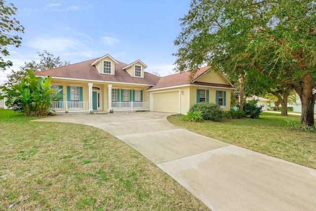 view of front of house featuring a garage, a front yard, and a porch