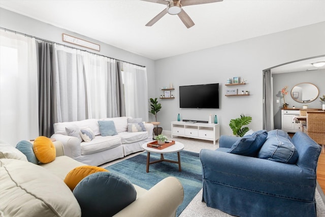 living room featuring ceiling fan and light wood-type flooring