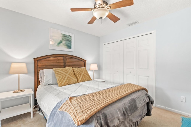 carpeted bedroom featuring a closet, ceiling fan, and a textured ceiling