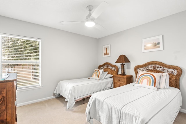 bedroom with ceiling fan and light carpet