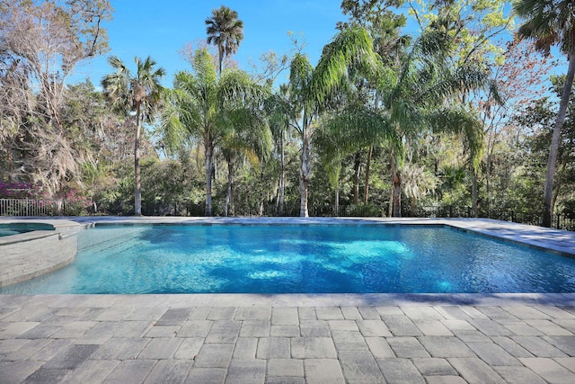 200 Manuel Ct, Saint Augustine, FL 32095 - view of pool with a pool with connected hot tub and fence