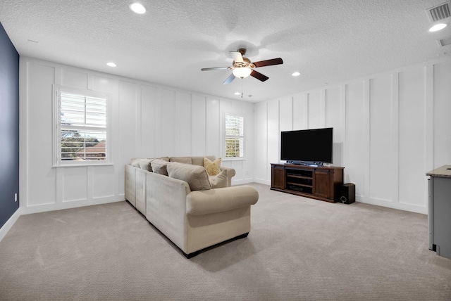200 Manuel Ct, Saint Augustine, FL 32095 - living area with a decorative wall, light colored carpet, visible vents, and ceiling fan