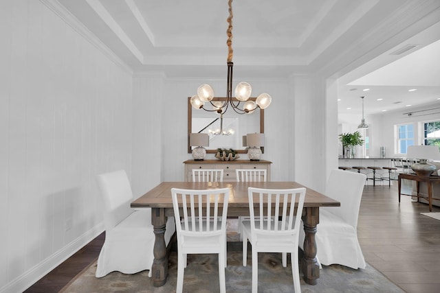 200 Manuel Ct, Saint Augustine, FL 32095 - dining area with a tray ceiling, an inviting chandelier, wood finished floors, and visible vents