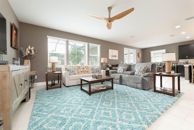 tiled living room with ceiling fan