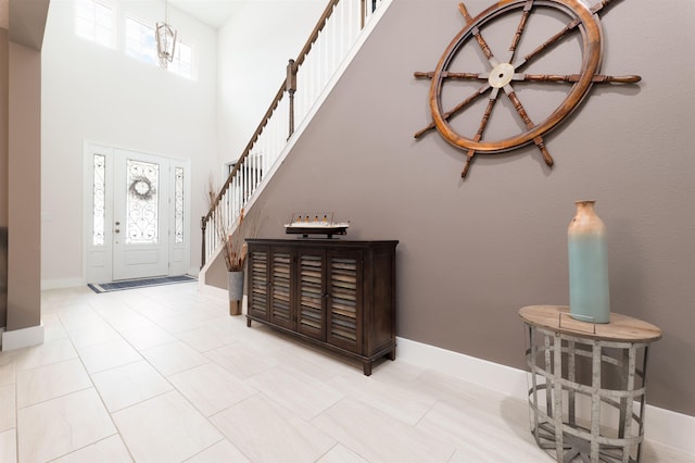 tiled entryway with a wealth of natural light and a high ceiling