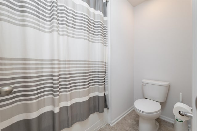 bathroom with toilet and shower / bath combo with shower curtain