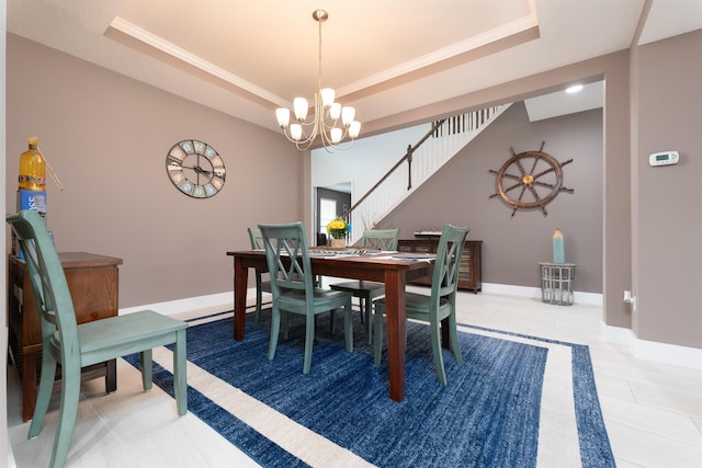 dining room with a tray ceiling and a notable chandelier