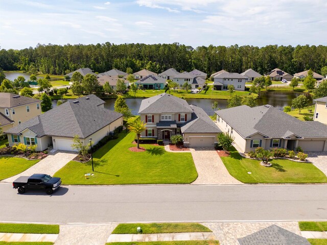 birds eye view of property with a water view