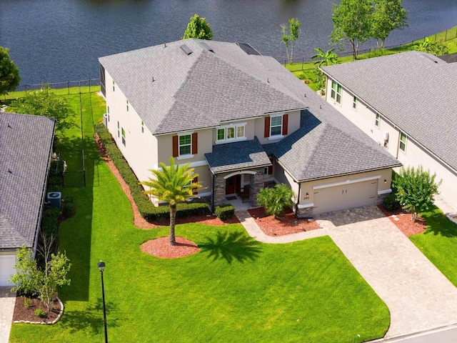 birds eye view of property with a water view