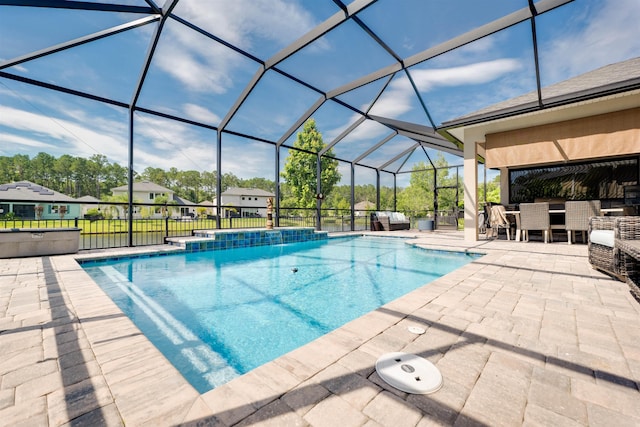 view of pool with a lanai, pool water feature, and a patio