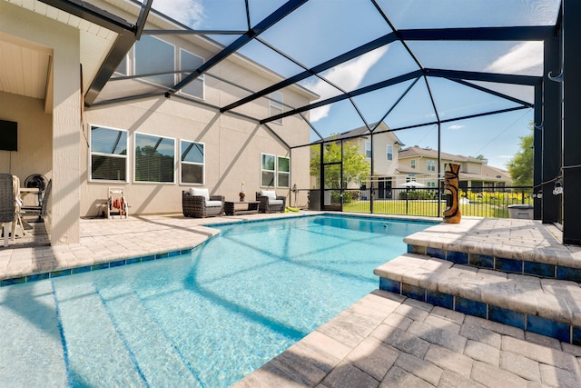 view of swimming pool featuring a patio and glass enclosure