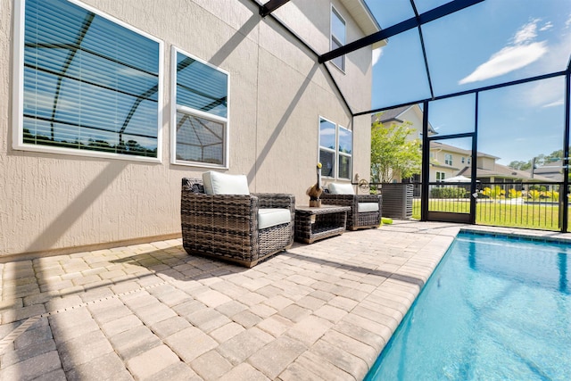 view of pool with glass enclosure and a patio