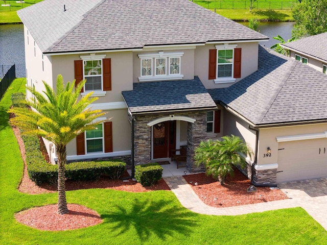 view of front of home with a garage and a front lawn