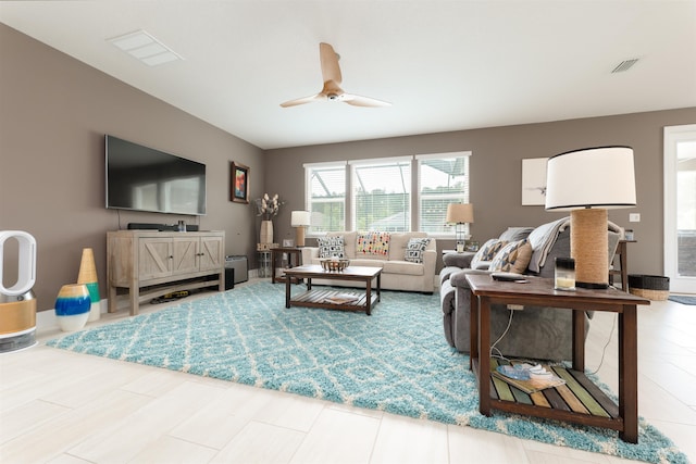 living room featuring tile patterned floors and ceiling fan