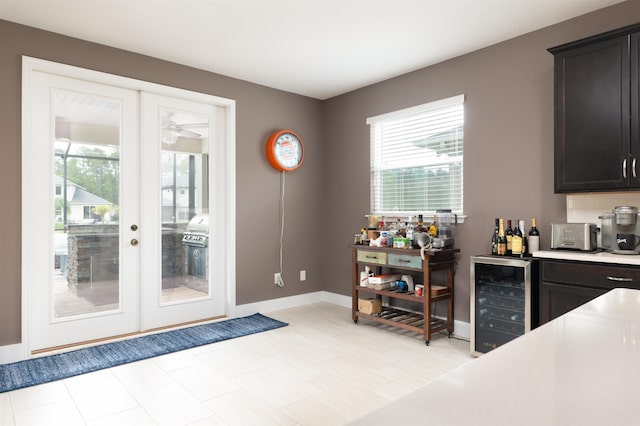 doorway to outside with french doors, beverage cooler, and a healthy amount of sunlight