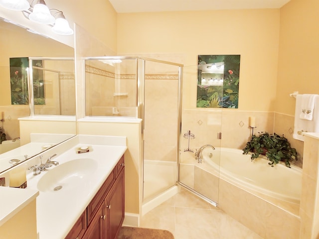 bathroom featuring shower with separate bathtub, vanity, and tile patterned floors