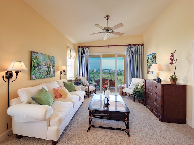 living room featuring ceiling fan, light carpet, and vaulted ceiling