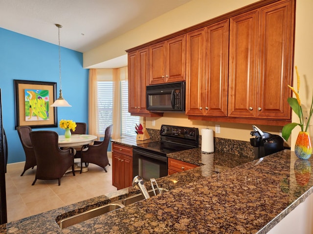 kitchen featuring pendant lighting, black appliances, sink, dark stone countertops, and light tile patterned floors