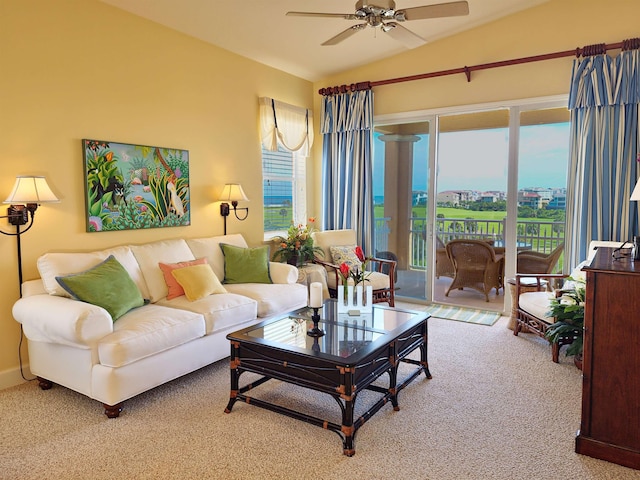 living room featuring ceiling fan, carpet floors, and lofted ceiling