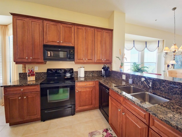 kitchen with dark stone counters, black appliances, sink, decorative light fixtures, and light tile patterned flooring