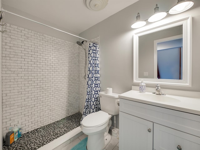 bathroom featuring a shower with shower curtain, vanity, tile patterned flooring, and toilet