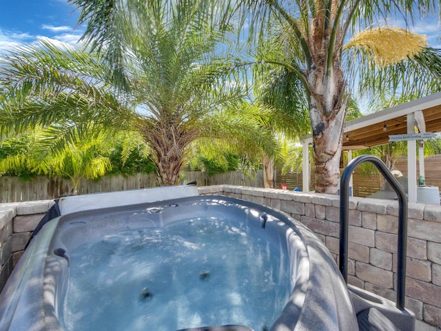 view of swimming pool featuring a hot tub