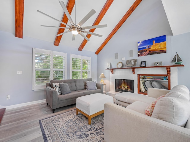 living room featuring ceiling fan, beam ceiling, light wood-type flooring, and high vaulted ceiling