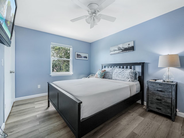 bedroom with ceiling fan and hardwood / wood-style floors