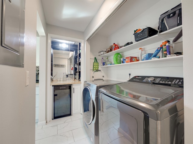 laundry room featuring washing machine and clothes dryer and wine cooler