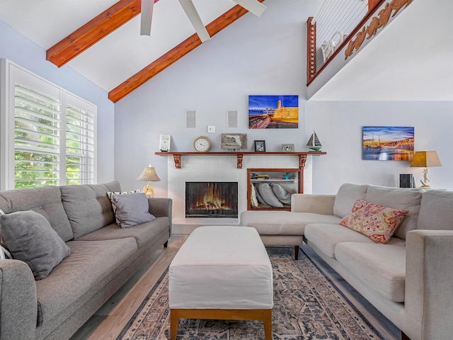 living room featuring hardwood / wood-style flooring, ceiling fan, beamed ceiling, and high vaulted ceiling