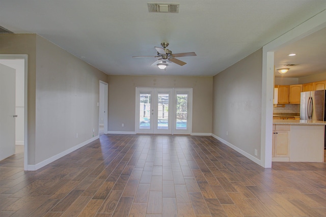 unfurnished living room with ceiling fan, french doors, and dark hardwood / wood-style floors