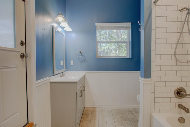 full bathroom featuring vanity, toilet, and tiled shower / bath combo