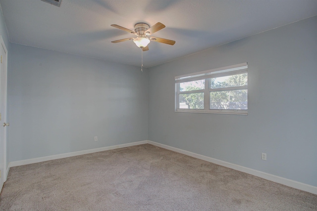 carpeted empty room featuring ceiling fan